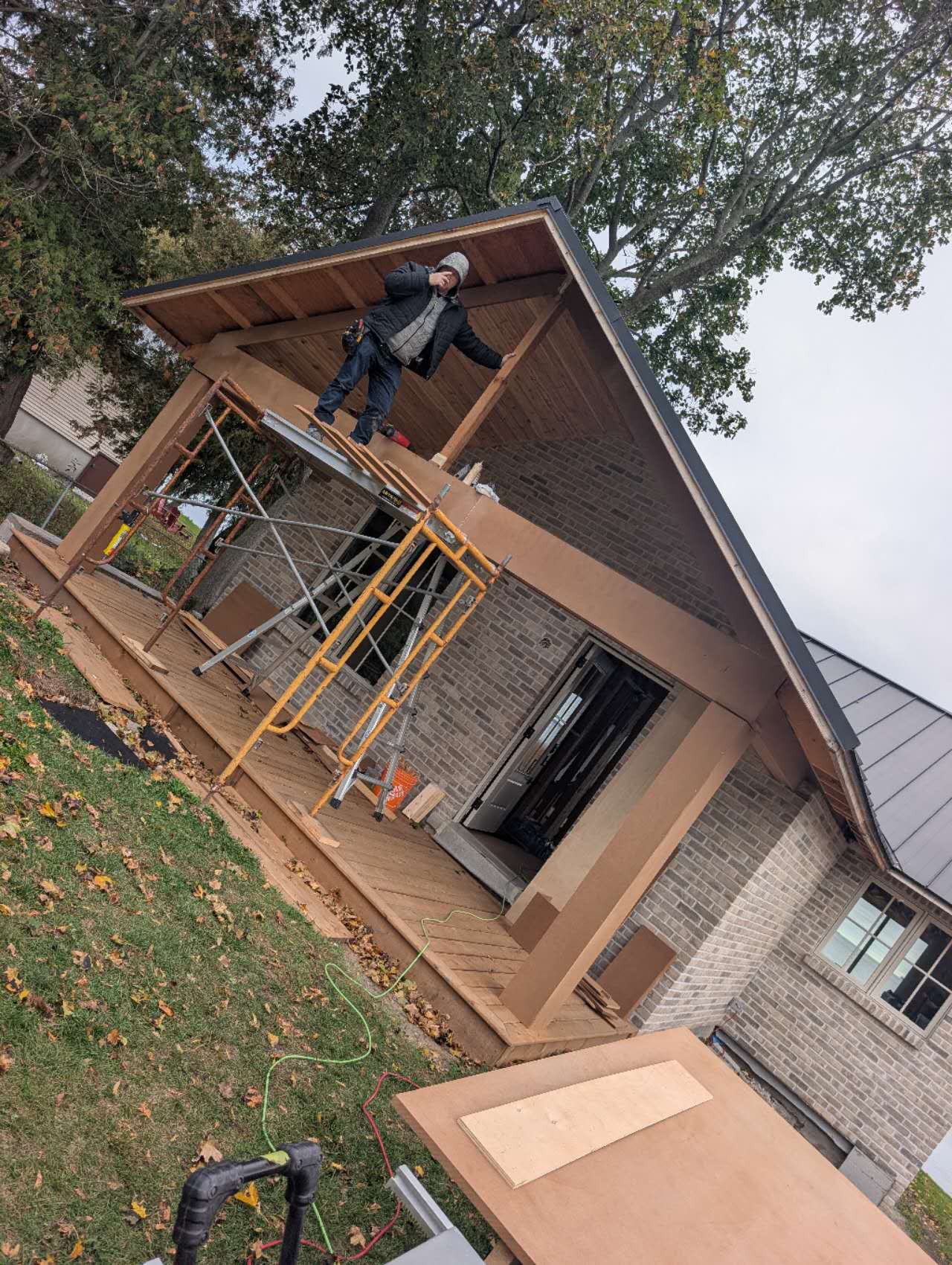 Carpenter cutting framing lumber with a Nakamura circular saw blade at an outdoor covered porch build Carpenter cutting framing lumber with a Nakamura circular saw blade at an outdoor covered porch build